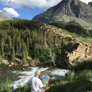 Painting, in Glacier National Park July 2019. You will see the final product in another thumbnail. It's quite a challenge, sometimes fighting the elements, and changing weather conditions. In this case, the mosquitos drove me off. I have found that the first outdoor session's product looks much better when I finish it in the studio at a later date. Me Painting in Glacier National Park July 2019